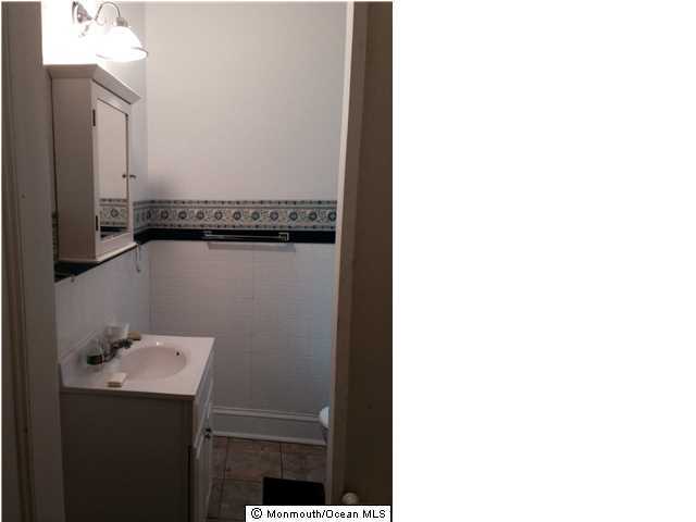 42 Washington Street Red Bank, NJ 07701 - Photo 6 of 6 a bathroom with a sink and mirror