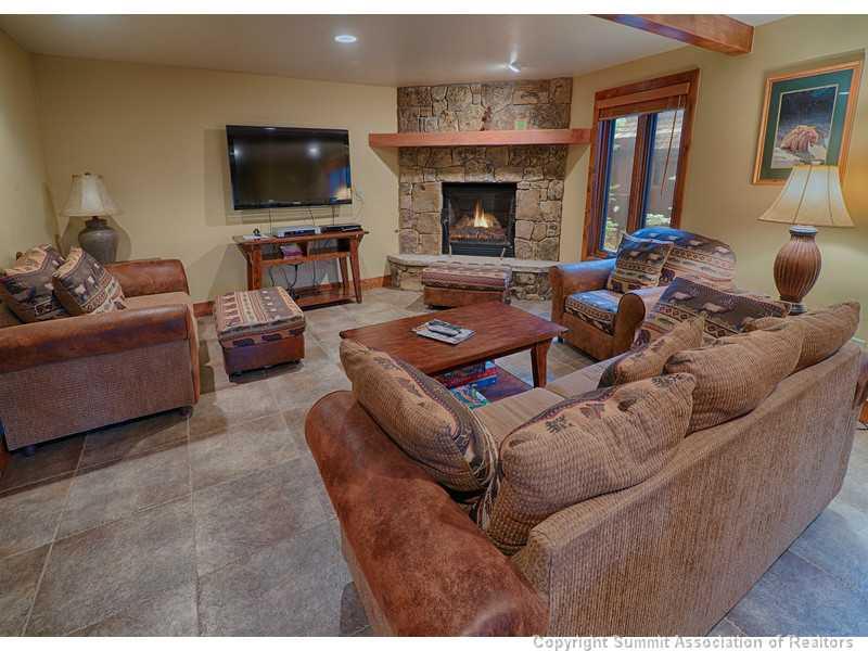 1005 4 O Clock Road Breckenridge, CO 80424 - Photo 11 of 24 a living room with furniture a flat screen tv and a fireplace