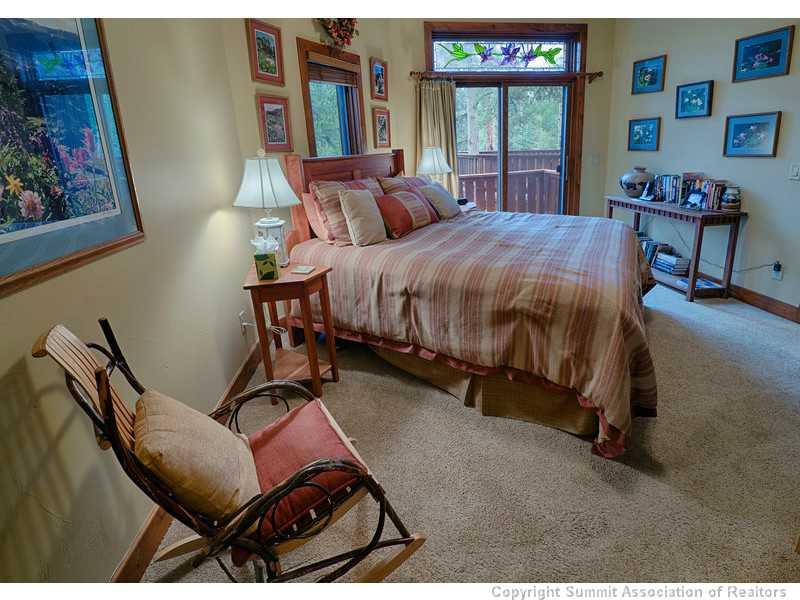 1005 4 O Clock Road Breckenridge, CO 80424 - Photo 13 of 24 a bedroom with a bed and large windows