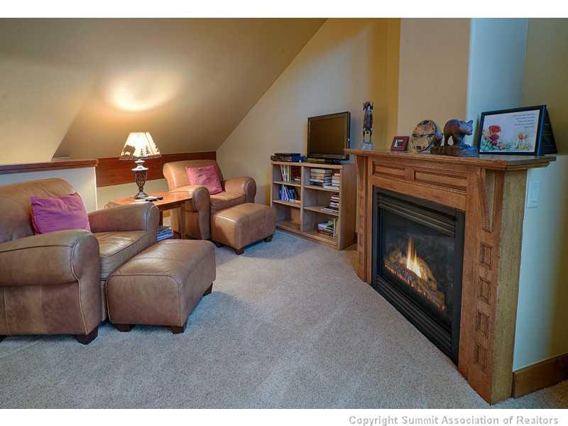 1005 4 O Clock Road Breckenridge, CO 80424 - Photo 20 of 24 a living room with furniture a flat screen tv and a fireplace
