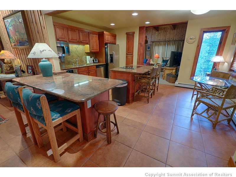 1005 4 O Clock Road Breckenridge, CO 80424 - Photo 8 of 24 a view of a dining room with furniture and a chandelier
