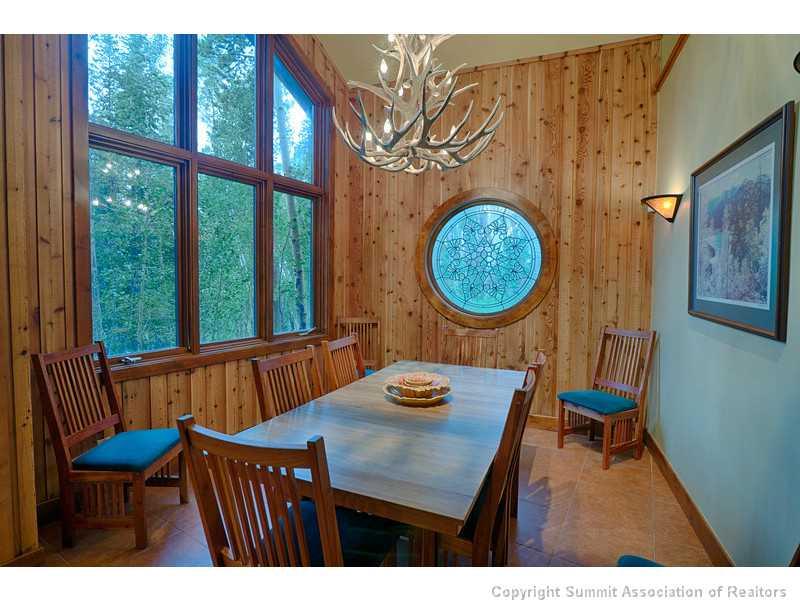 1005 4 O Clock Road Breckenridge, CO 80424 - Photo 9 of 24 a view of a dining room with furniture and a large window