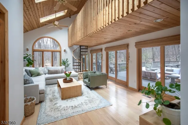 a living room with furniture fireplace and potted plants