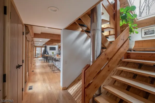 a view of entryway and hall with wooden floor
