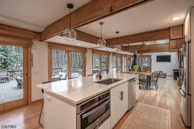 a kitchen with stainless steel appliances granite countertop a stove and a refrigerator