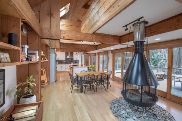 a dining room with furniture window and wooden floor