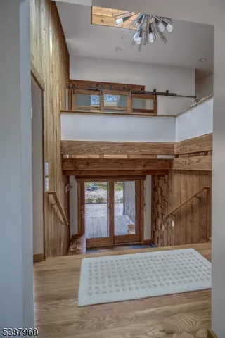 a view of a hallway with wooden floor and a fireplace