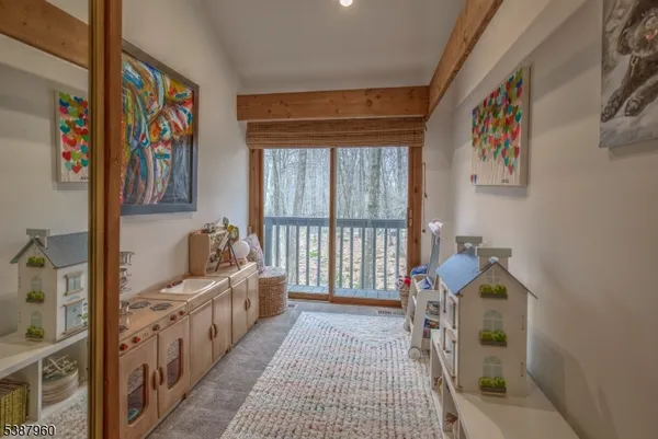 a view of a hallway to a livingroom with furniture