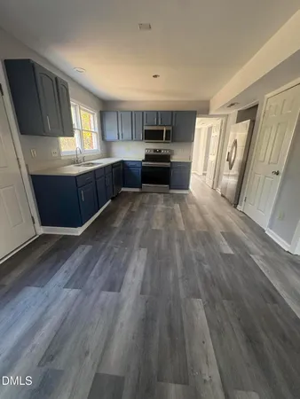 a view of kitchen and hall with wooden floor