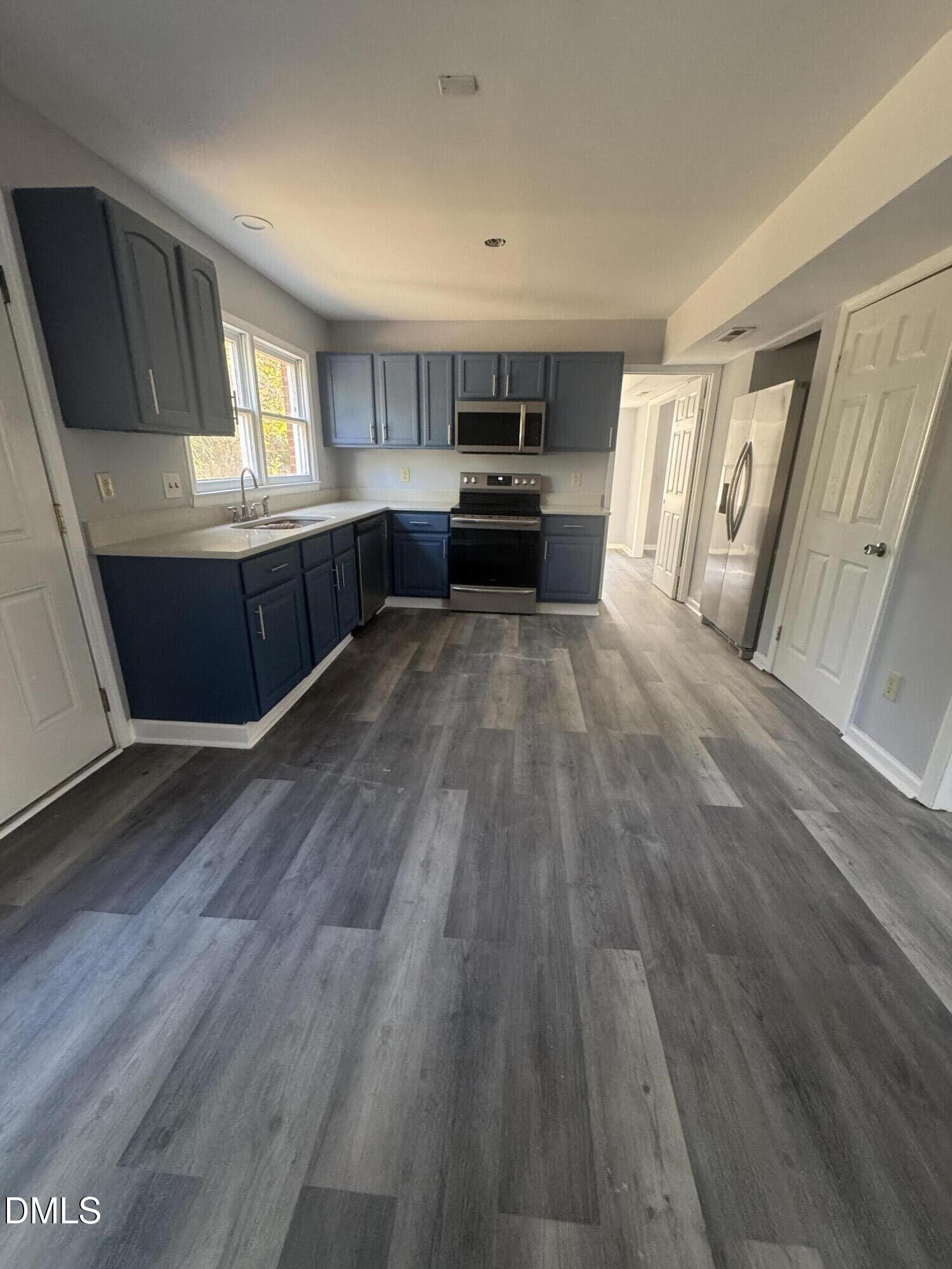 2513 Foxgate Drive Raleigh, NC 27610 - Photo 4 of 7 a view of kitchen and hall with wooden floor