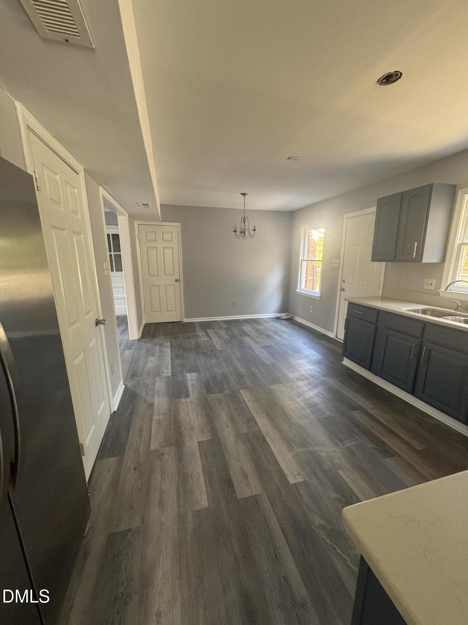 2513 Foxgate Drive Raleigh, NC 27610 - Photo 5 of 7 a view of empty room with wooden floor