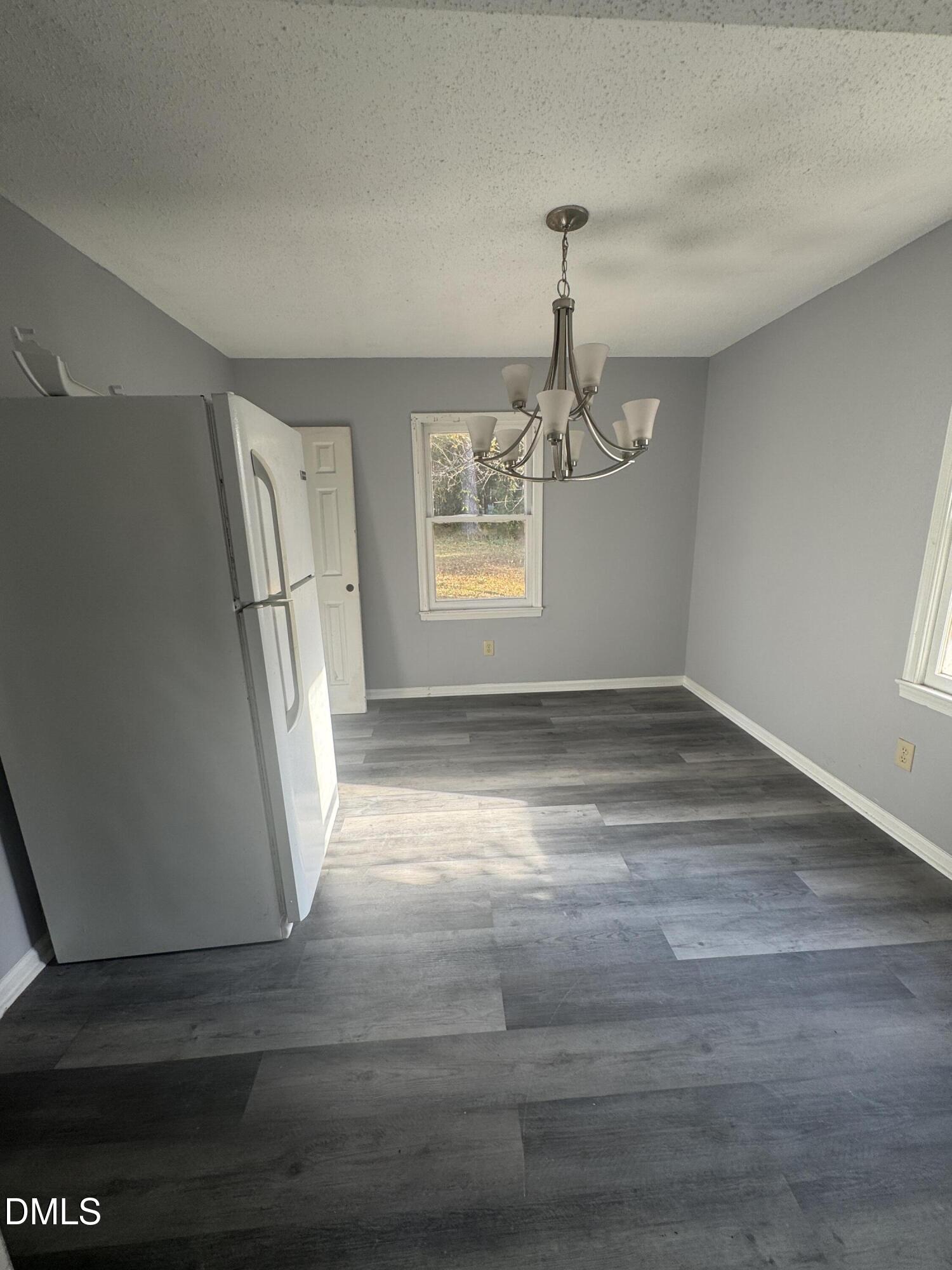 2513 Foxgate Drive Raleigh, NC 27610 - Photo 6 of 7 a view of empty room with wooden floor and fan