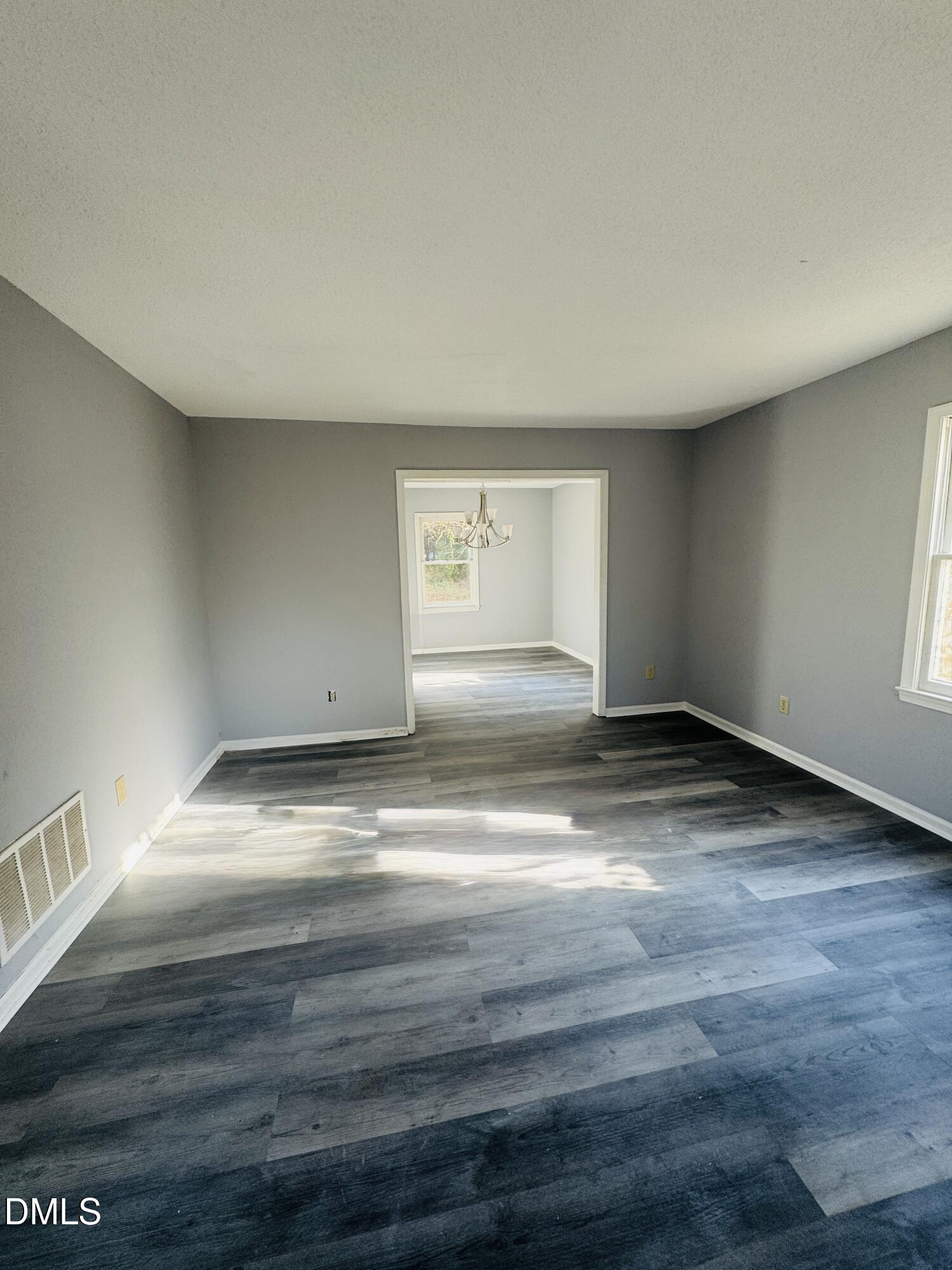 2513 Foxgate Drive Raleigh, NC 27610 - Photo 7 of 7 a view of empty room with wooden floor