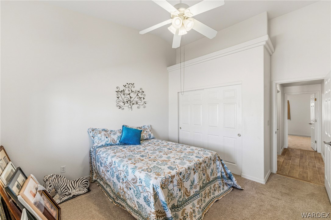 9332 Branded Road Kingman, AZ 86401 - Photo 23 of 44 a bedroom with a bed and a chandelier