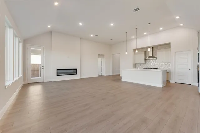 a view of a kitchen with a sink and a refrigerator
