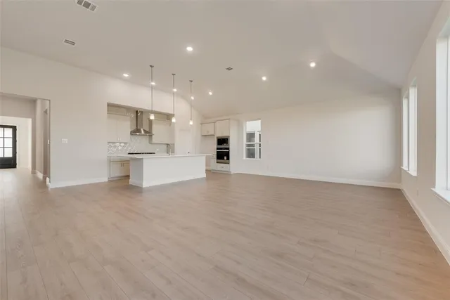 a view of a kitchen with a sink and a refrigerator