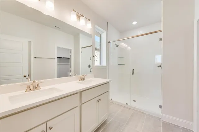 a bathroom with a shower sink and mirror