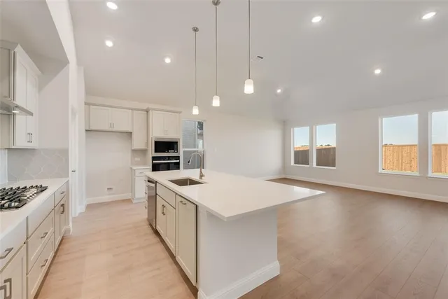 a kitchen with a stove a sink and a refrigerator