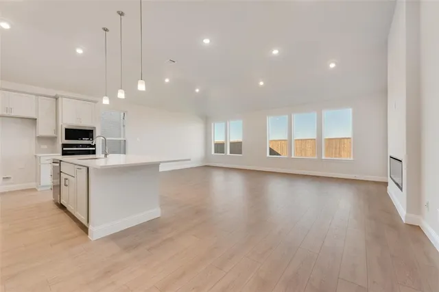 a view of kitchen with microwave and refrigerator