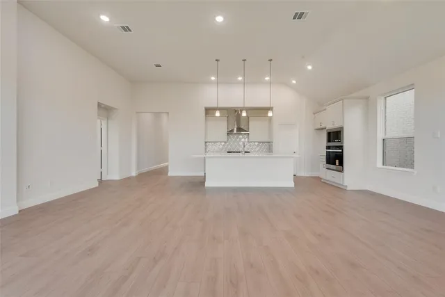 a view of a kitchen with a sink and a refrigerator