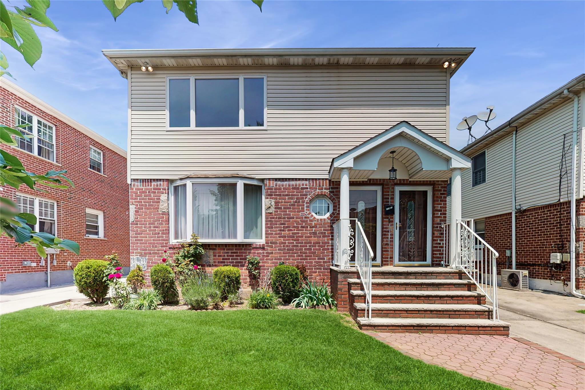250-01 Elkmont Avenue Queens, NY 11426 - Photo 1 of 1 a front view of a house with a yard