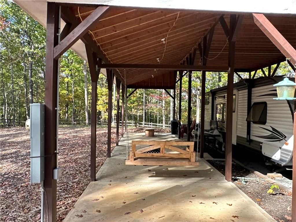 1806 Browning Road Rockmart, GA 30153 - Photo 3 of 89 a view of a patio with table and chairs under an umbrella with a small yard