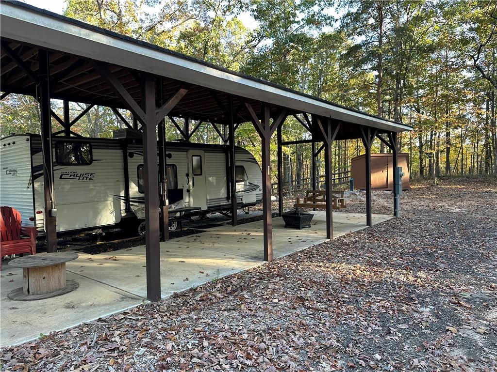 1806 Browning Road Rockmart, GA 30153 - Photo 9 of 89 a view of a patio with a table chairs and a floor to ceiling window