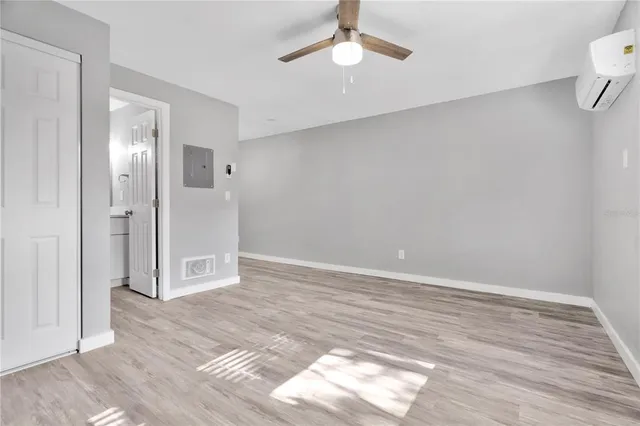 wooden floor in an empty room with a window