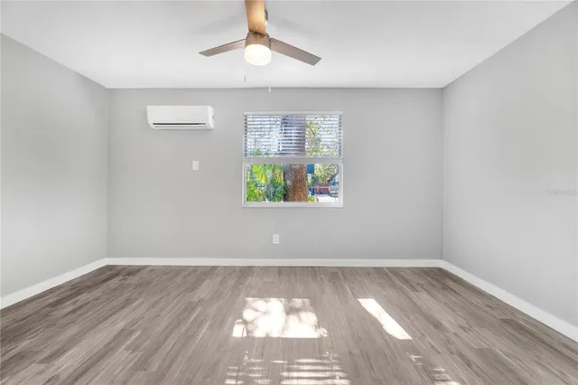 wooden floor in an empty room with a window