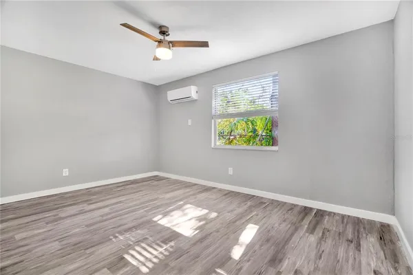 wooden floor in an empty room with a window