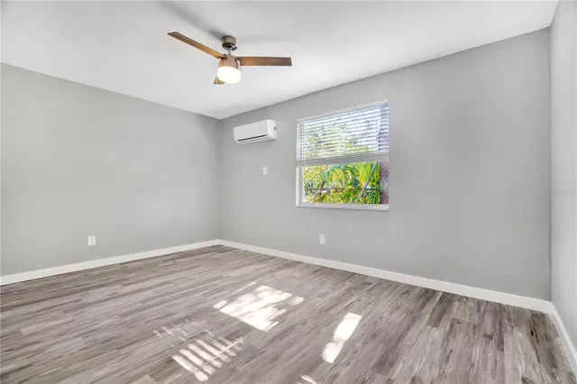 wooden floor in an empty room with a window