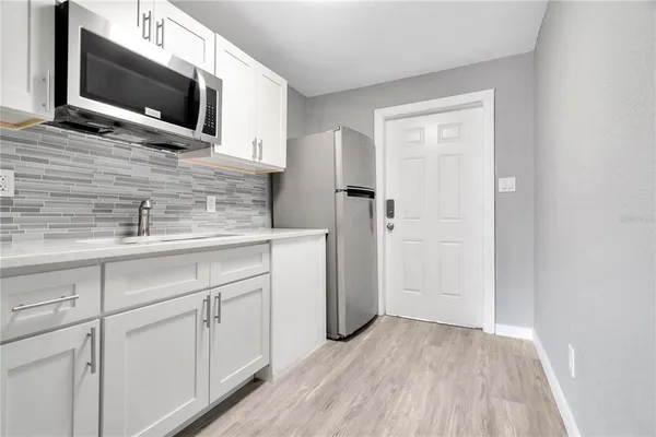 a kitchen with stainless steel appliances white cabinets and a microwave oven