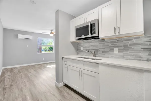 a kitchen with stainless steel appliances granite countertop a sink and a microwave
