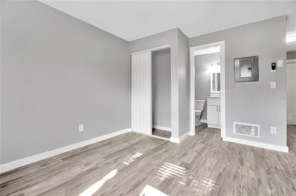 a view of a room with wooden floor and bathroom
