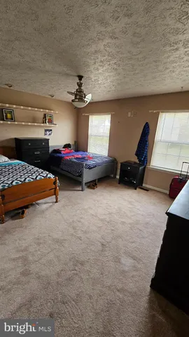 a bedroom with furniture and a baby crib