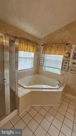 a view of a hallway with wooden floor and stairs