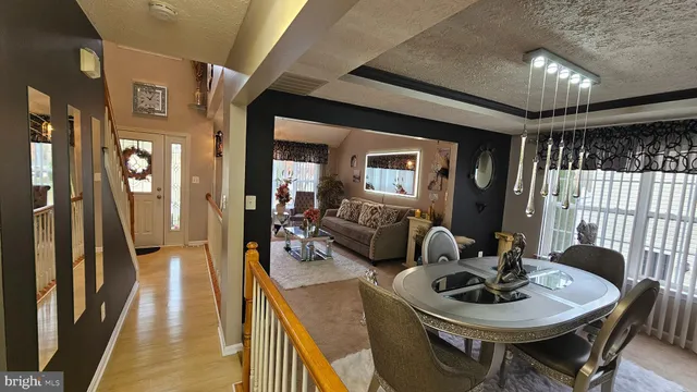 a dining room with furniture and wooden floor