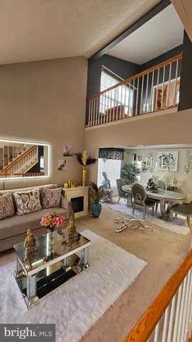 a living room with furniture gym equipment and a rug