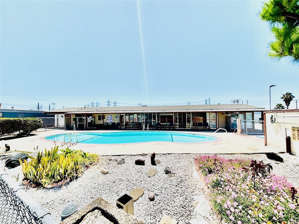 16601 Garfield Avenue, Unit 110 Paramount, CA 90723 - Photo 21 of 22 a view of a swimming pool with a lounge chair