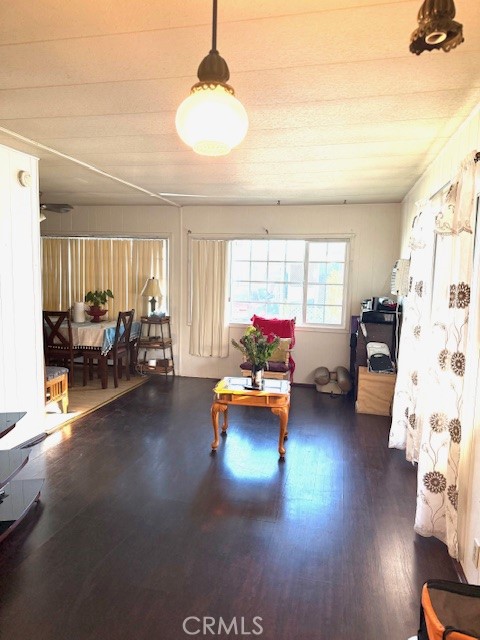 16601 Garfield Avenue, Unit 110 Paramount, CA 90723 - Photo 10 of 22 a living room with furniture and a chandelier