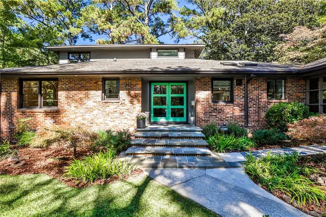 a front view of a house with garden