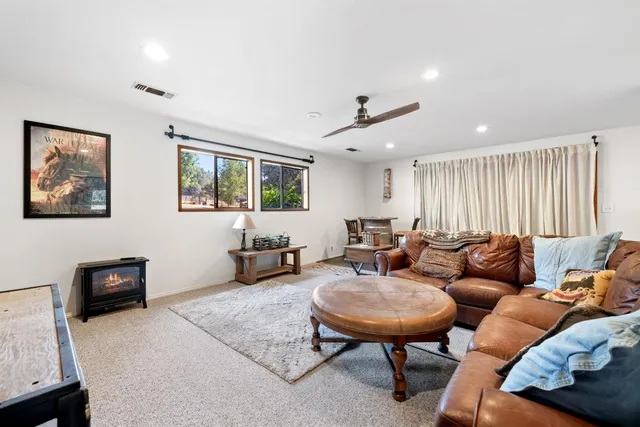 a bedroom with a bed a couch and a window