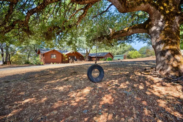 a living room with furniture a chandelier and a large window