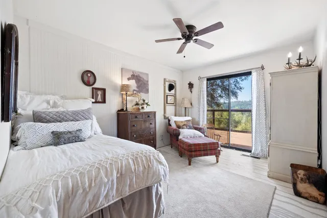 a bathroom with a granite countertop toilet sink and mirror
