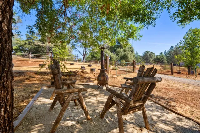 a view of a backyard with sitting area