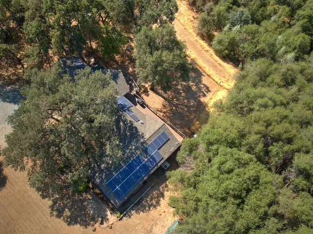 an aerial view of residential houses with outdoor space