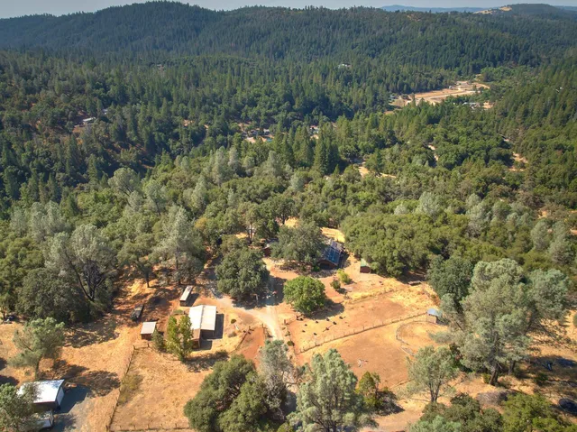 a view of a houses with a lush green hillside