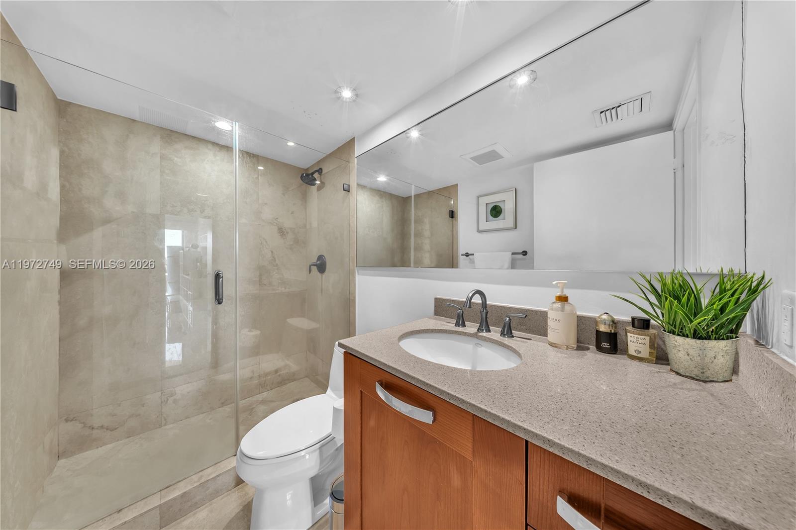 Key Colony Condominiums Key Biscayne, FL 33149 - Photo 13 of 20 a bathroom with a sink a toilet and shower