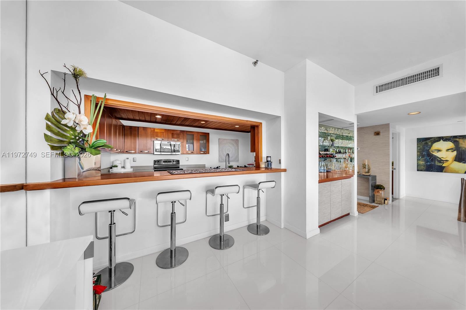 Key Colony Condominiums Key Biscayne, FL 33149 - Photo 8 of 20 a kitchen with white cabinets and window