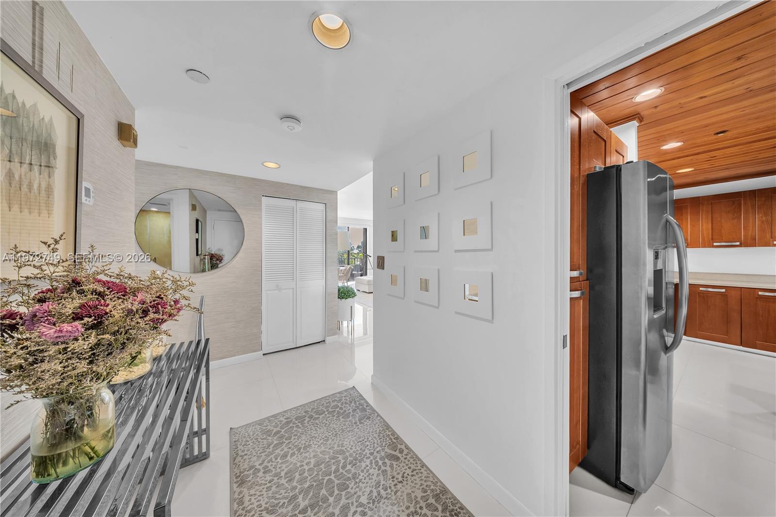 Key Colony Condominiums Key Biscayne, FL 33149 - Photo 9 of 20 a view of a hallway to dining room and wooden floor